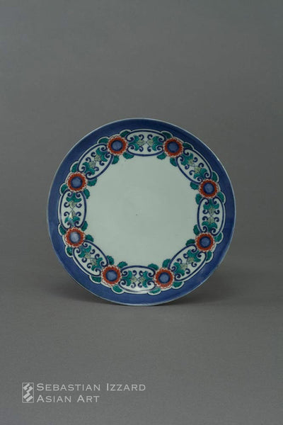 A PORCELAIN DISH  Hizen ware, Nabeshima type:  porcelain with underglaze blue and colored enamel decoration Edo period, Empo/Jokyo eras (1673−87) D: 19.3 cm