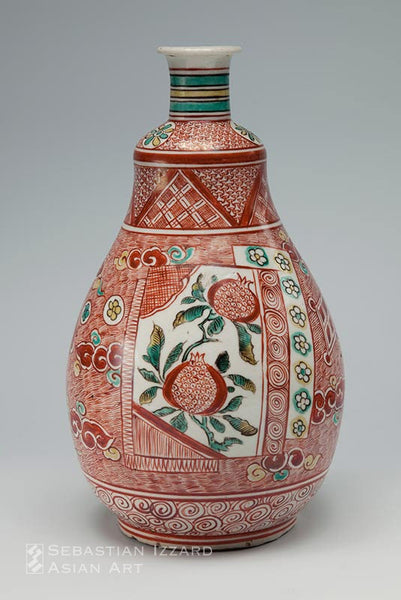 WINE BOTTLE WITH FLORAL PANEL DECORATION  Hizen ware, Kokutani type: porcelain with overglaze iron-red and yellow and green enamels  Kambun era, 1661–72 Height 25.1 cm