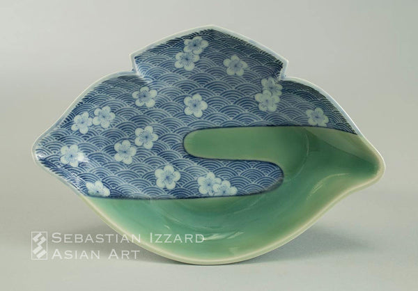 Small Molded Dish with Design of Plum Blossoms on Waves Hizen ware, Nabeshima type: porcelain with underglaze blue and celadon  Edo period, circa 1670 18.1 x 12.1 x 4.1 cm