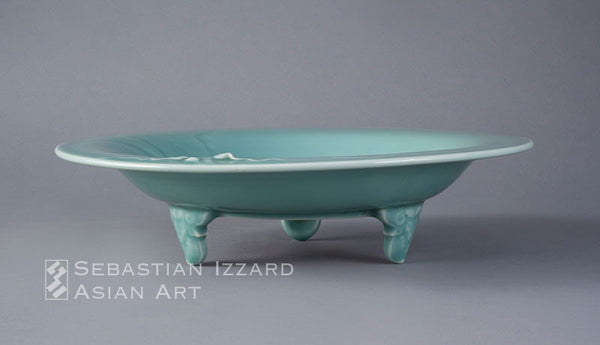 FOOTED DISH (SHAKUZARA) WITH MELON AND LEAFING VINE DESIGN Hizen ware, Nabeshima type: porcelain with carved decoration under celadon glaze  Edo period (1615–1868), Genroku era, circa 1700 Height 2-5/8 in. (6.7 cm); diameter 11¼ in. (28.7 cm)